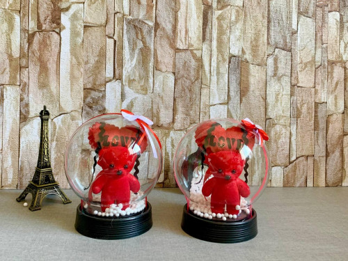 Valentine's Day gift: teddy bear with heart and flower in a glass ball